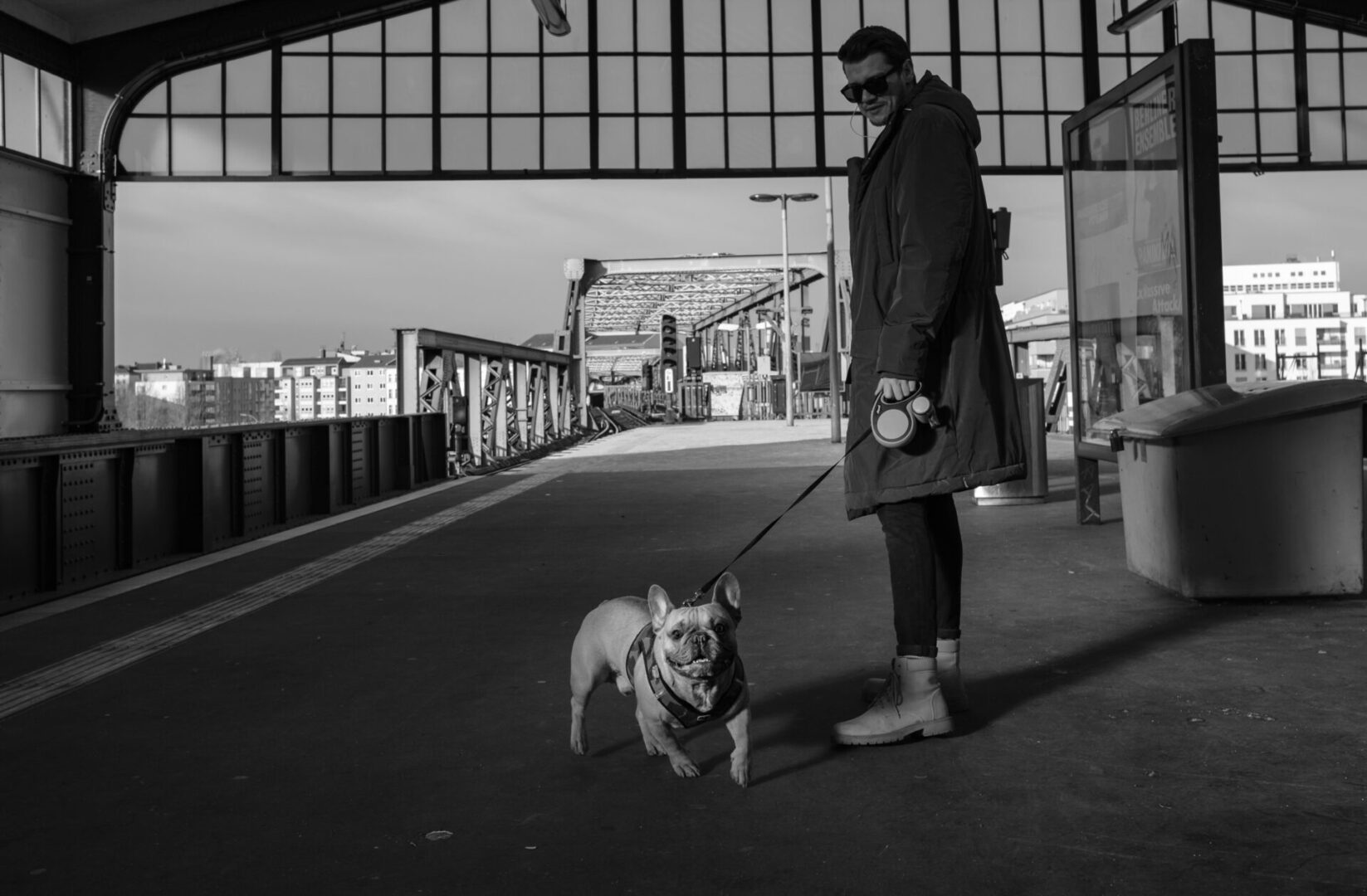 A woman walking her dog on a leash.