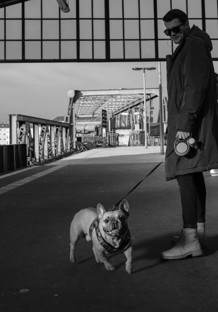 A woman walking her dog on a leash.